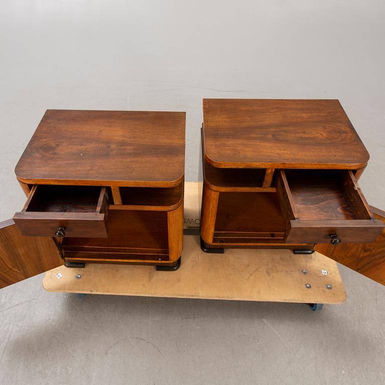 A pair of walnut/mahogany bedside tables first half of the 20th century.