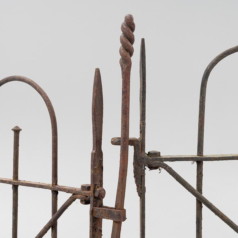 A pair of iron garden gates and a single gate from the early 20th century.