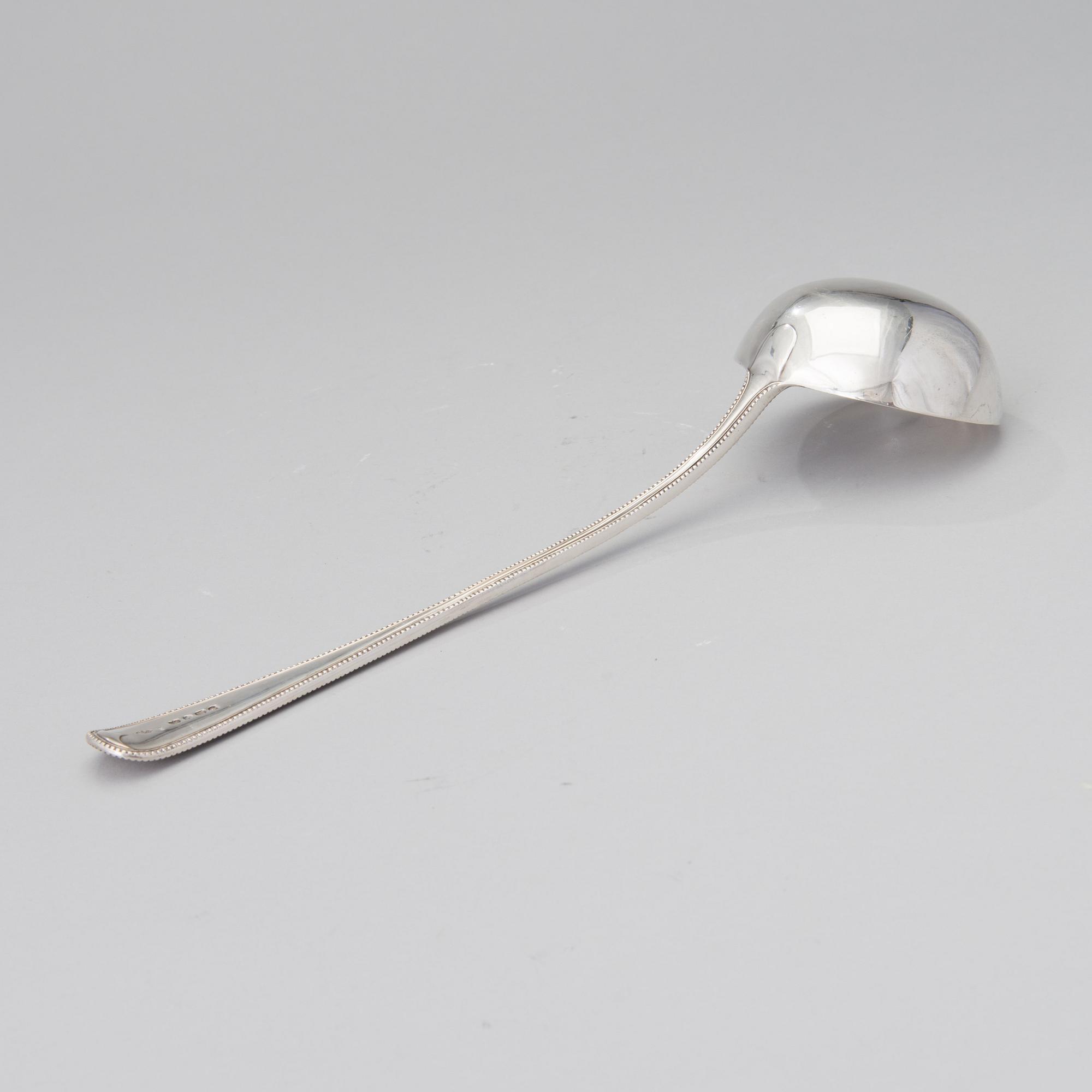A soup ladle in sterling silver, mark of George William Adams, London 1867.
