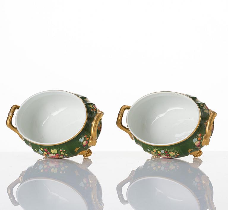 A pair of armorial butter tureens with covers and stands and two fruit dishes, Derby, England, circa 1830.