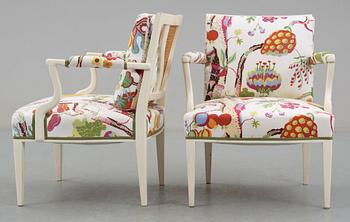 A pair of Josef Frank white lacquered and rattan armchairs by Svenskt Tenn.