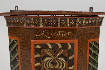 A folk art corner cabinet.