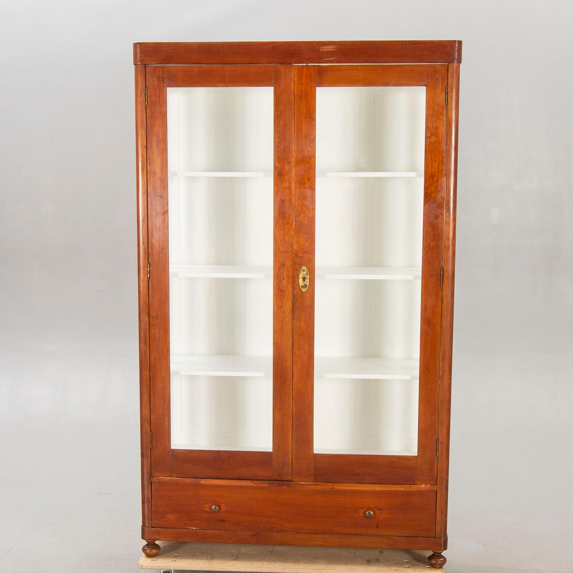 An early 1900s walnut display cabinet.