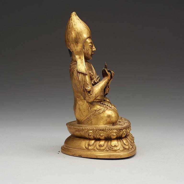 A Sino-Tibetan gilt copper alloy repoussé figure of Tsong Khapa, 18/19th Century.