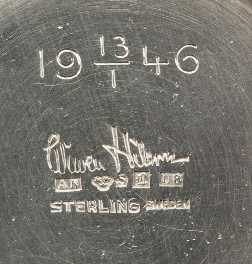 A Swedish 20th century sterling set of three sandwich spoons ad a beaker mark of W Nilsson Lund 1965, 1967 and 1946,