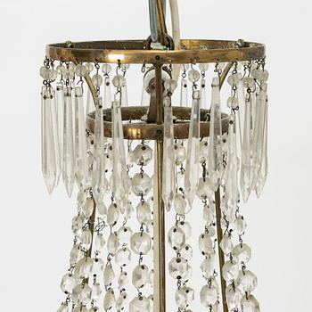 An Empire-style six-branch chandelier, circa 1900.