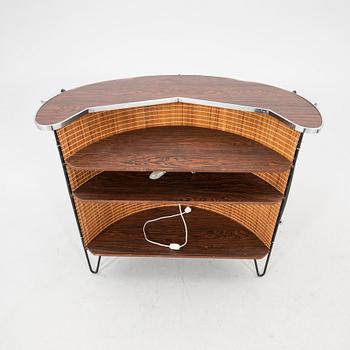 A 1970s bar and four stools.