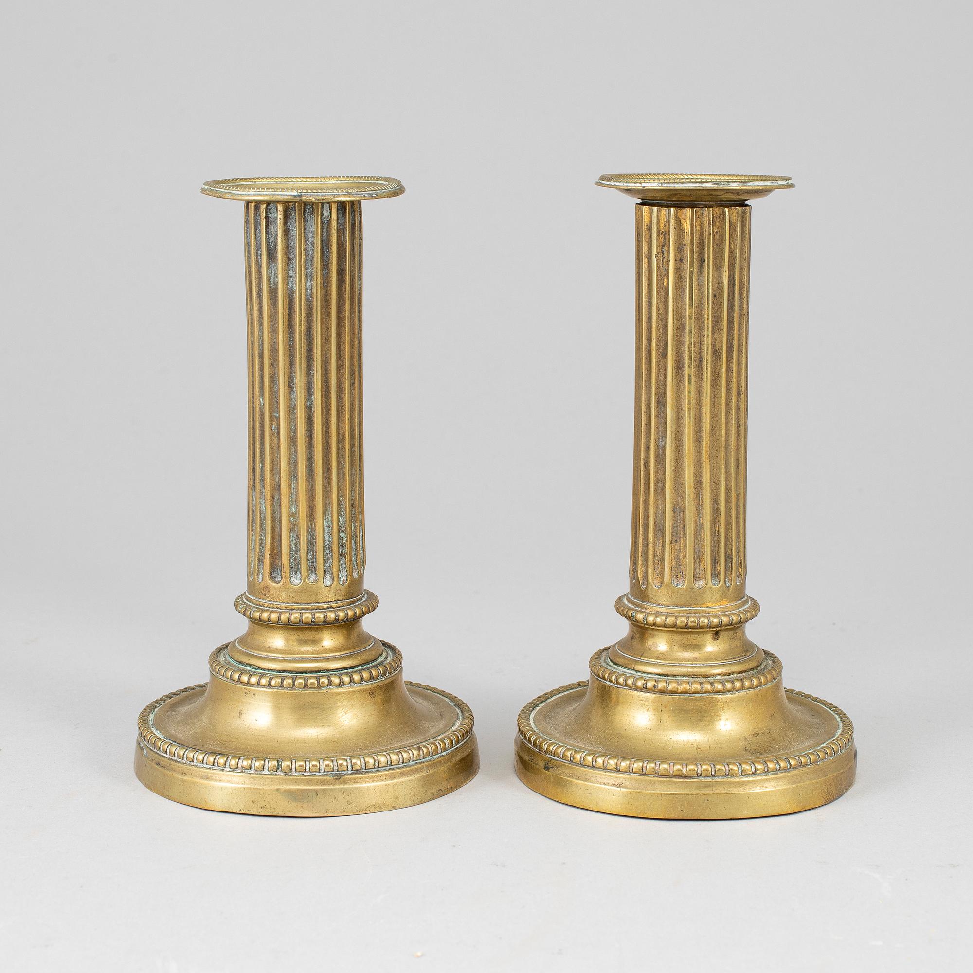 A pair of Louis Seize bronze candlesticks.