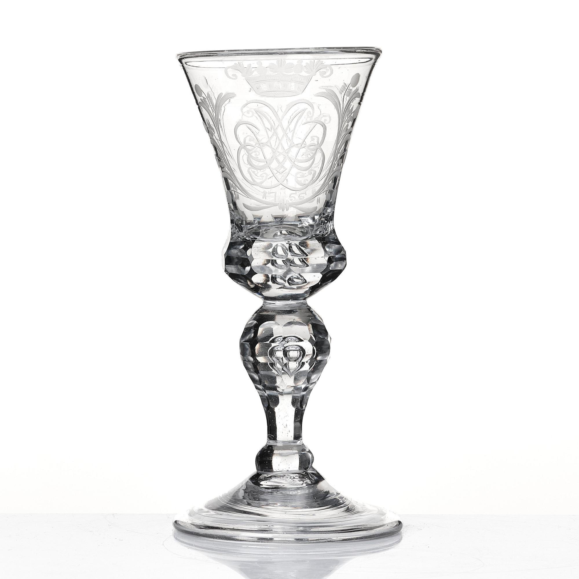 A cut and engraved glass goblet, dated 1755.