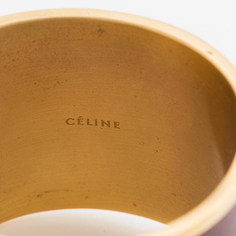 Céline, armring, guldfärgad metall och skinn.