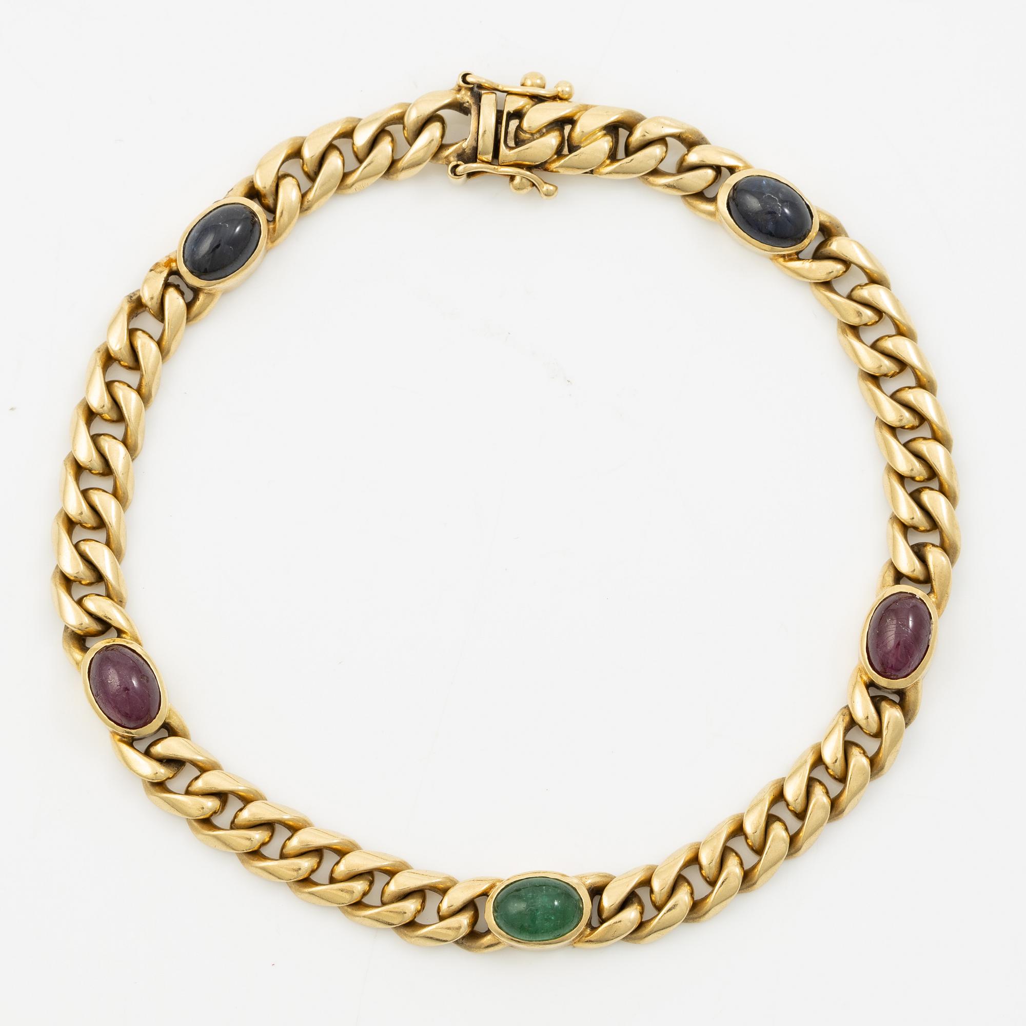 Bracelet in 18K gold set with cabochon-cut emeralds, rubies, and sapphires.