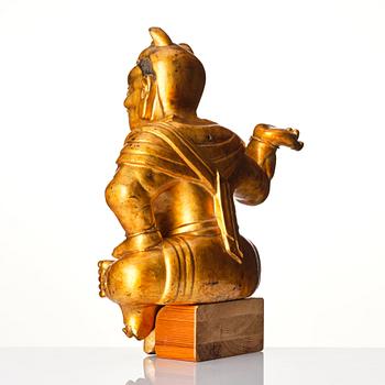 A gilt and lacquered wooden sculpture of a guardsman, Qing dynasty, 18th century.
