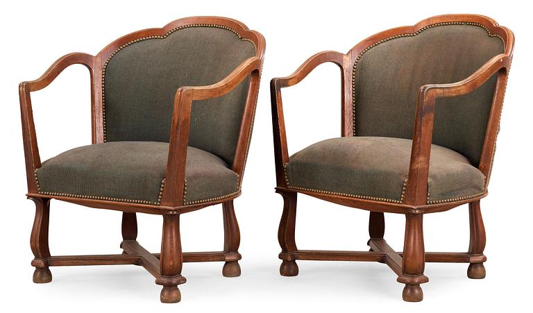 A pair of Ragnar Östman oak easy chairs, Sweden 1920's.