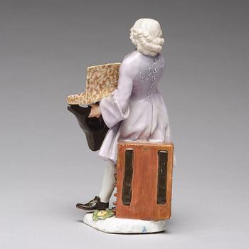 A Meissen porcelain figure of a trinket salesman from the series of Parisian street-traders, circa 1745.