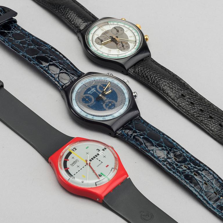 Three watches and one book by Swatch.