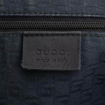 Gucci, a leather bag.