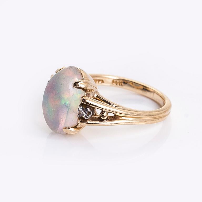 Ring in 14K gold with an oval opal and diamonds.
