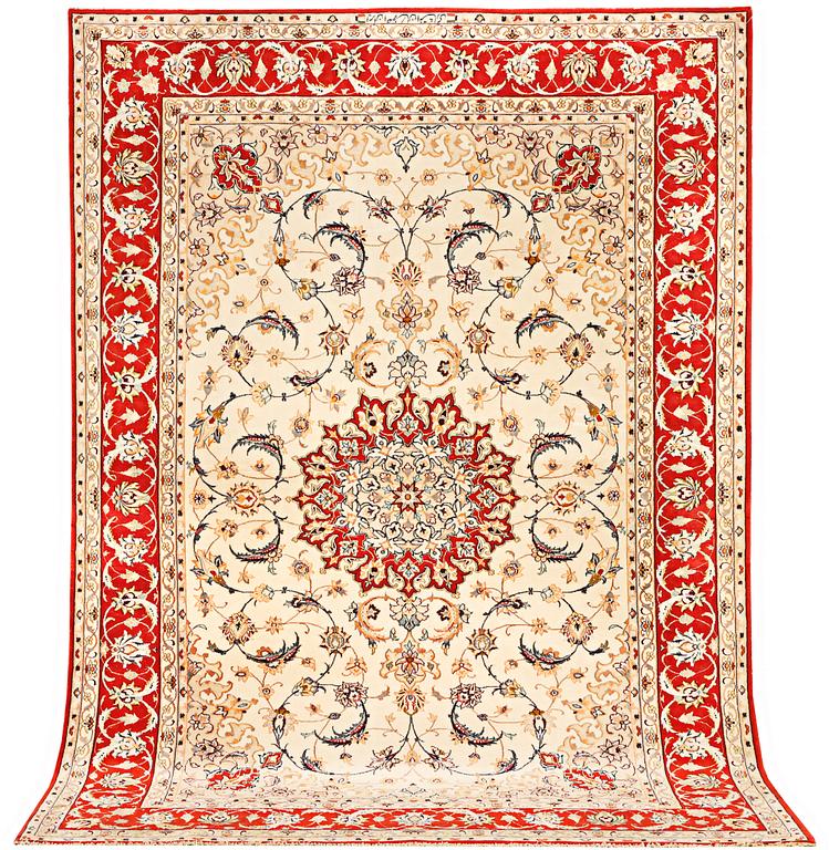 A semi-antique part silk Isfahan rug, a. 238 x 156 cm.