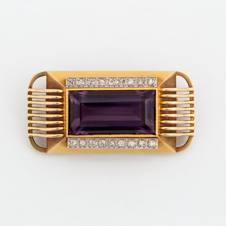 A 14K gold brooch set with a faceted amethyst and eight-cut diamonds.