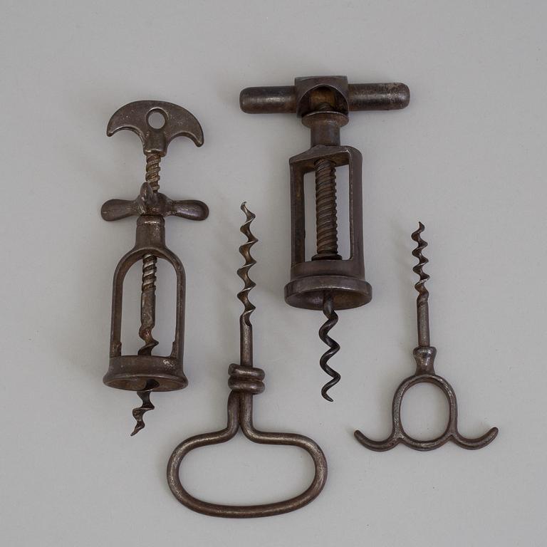 FOUR CAST IRON CORK SCREWS, 19th century.