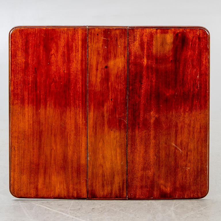A 20th century English mahogany folding table.