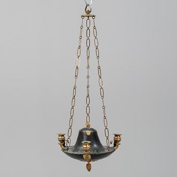 A Swedish Empire style 20th century three-light patinated brass hanging-lamp.