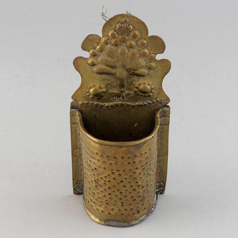 A 17th century brass spoon holder.