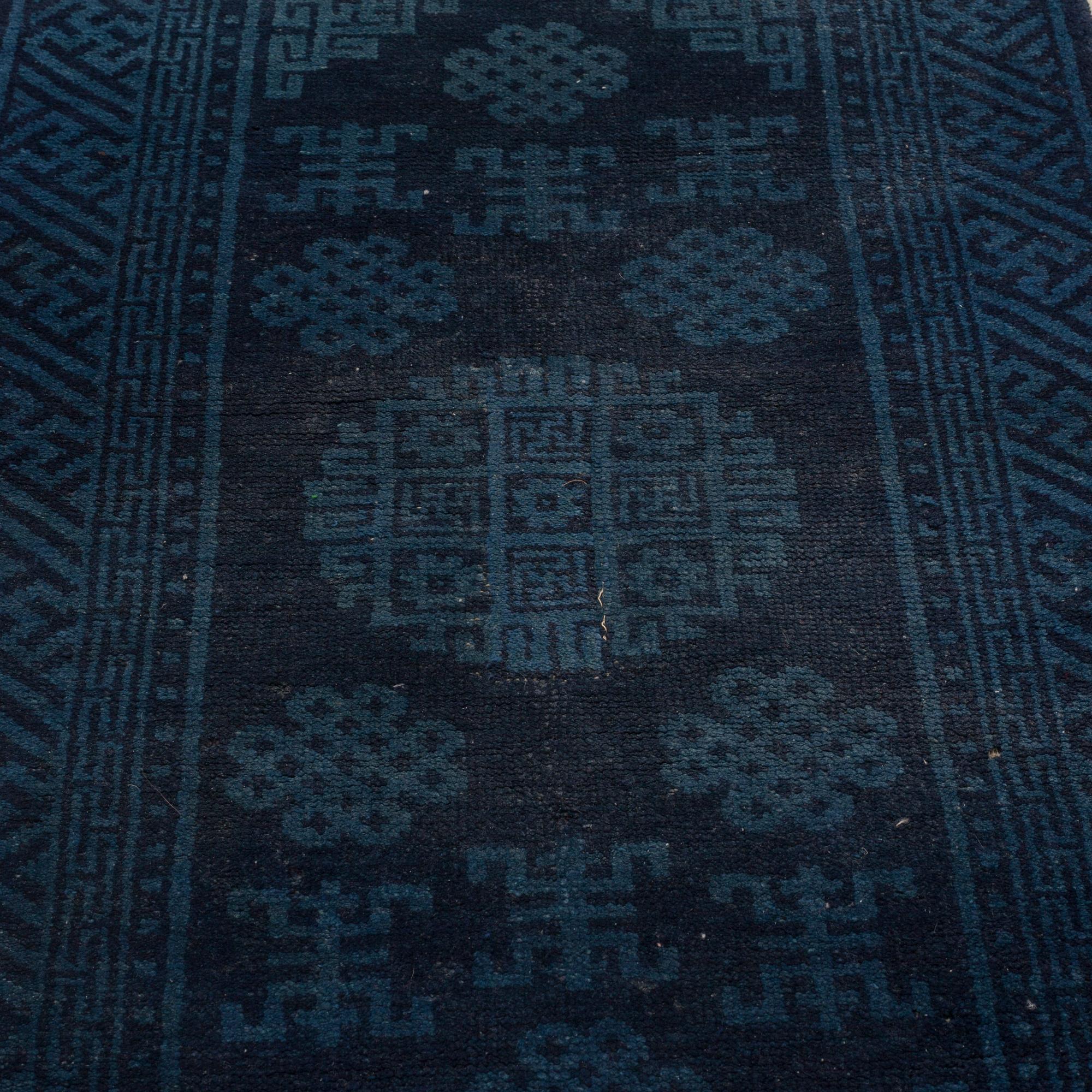 A RUG, a semi-antique Baotou, ca 108 x 54,5 cm.