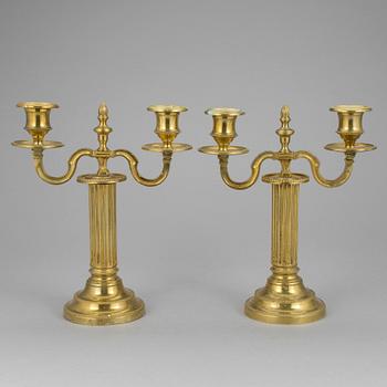 A pair of french 18th century brass candelabras.