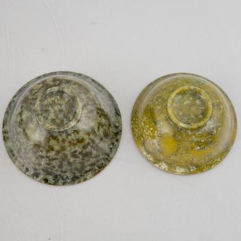 A group of ten Chinese spinach green stone bowls.