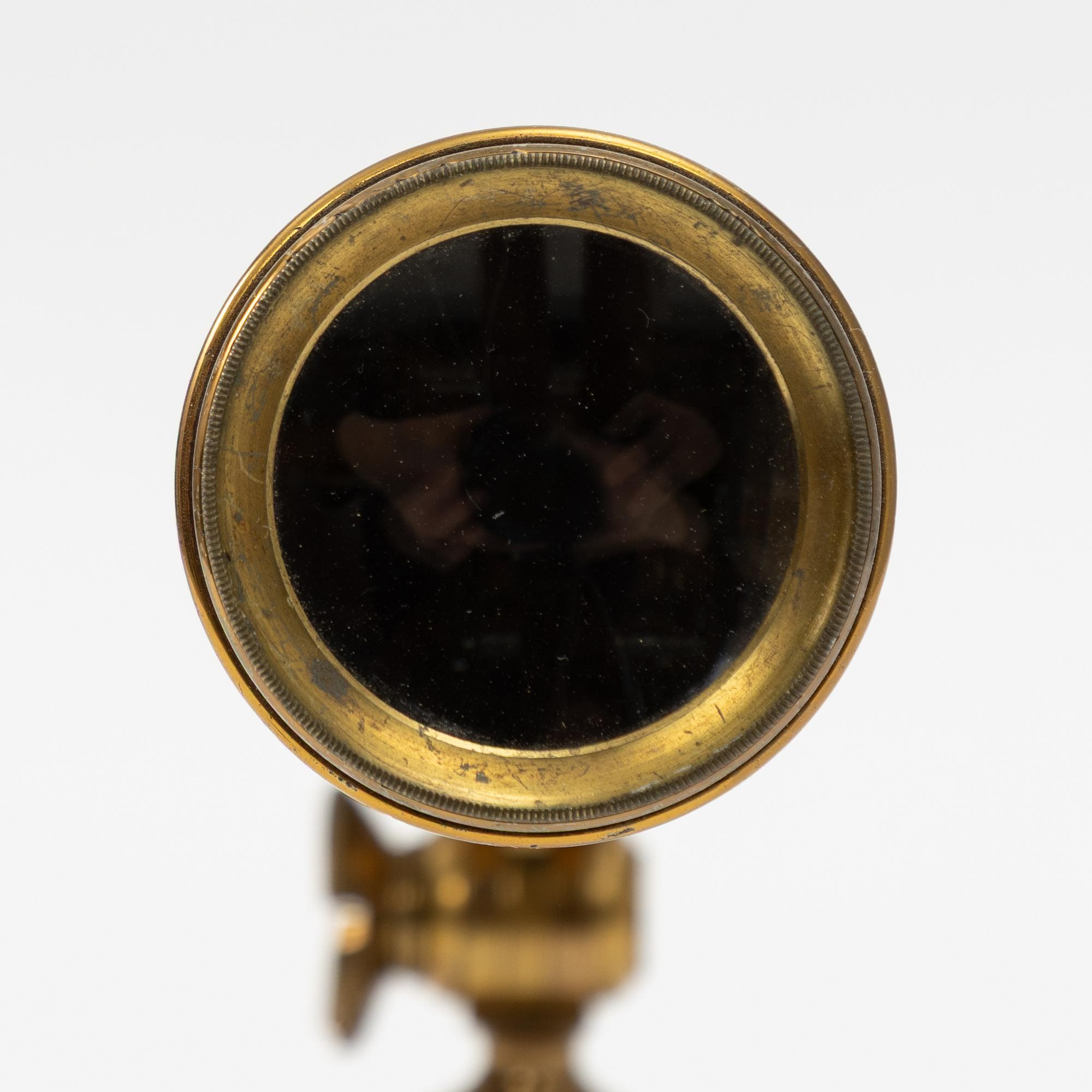 A telescope on a tripod, 19th/20th century.