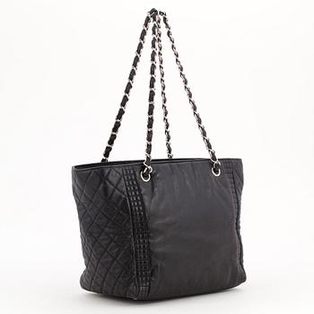 CHANEL, a black quilted leather bag.