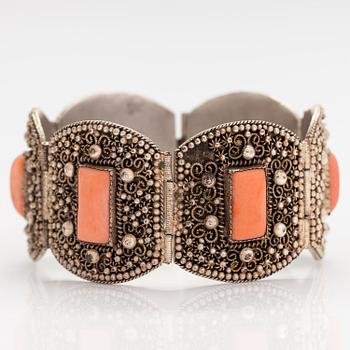 A silver bracelet with corals.