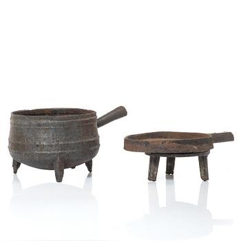 A cast-iron cauldron and frying pan on stand, 17th / 18th century.