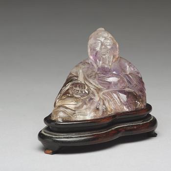 A Chinese quartz figurine of one of the immortals.