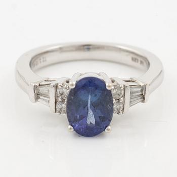 Ring in 14K gold set with a faceted tanzanite and diamonds in various cuts.