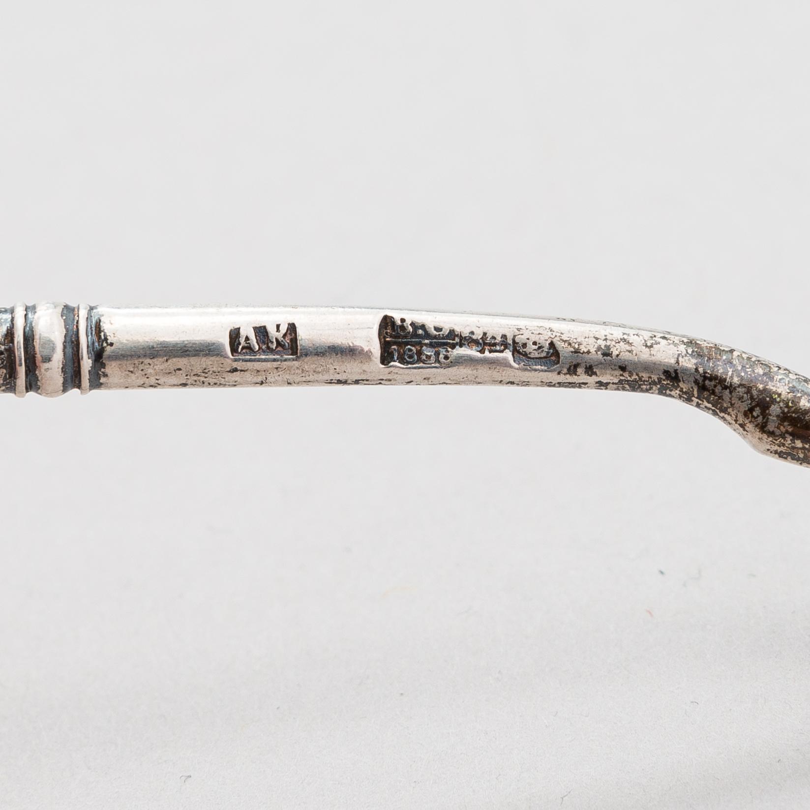 A Russian silver tea glass holder and a tea spoon, Moscow, Alexander Fuld 1889 and Antip Kuzmichev 1888. Glass, Finland.