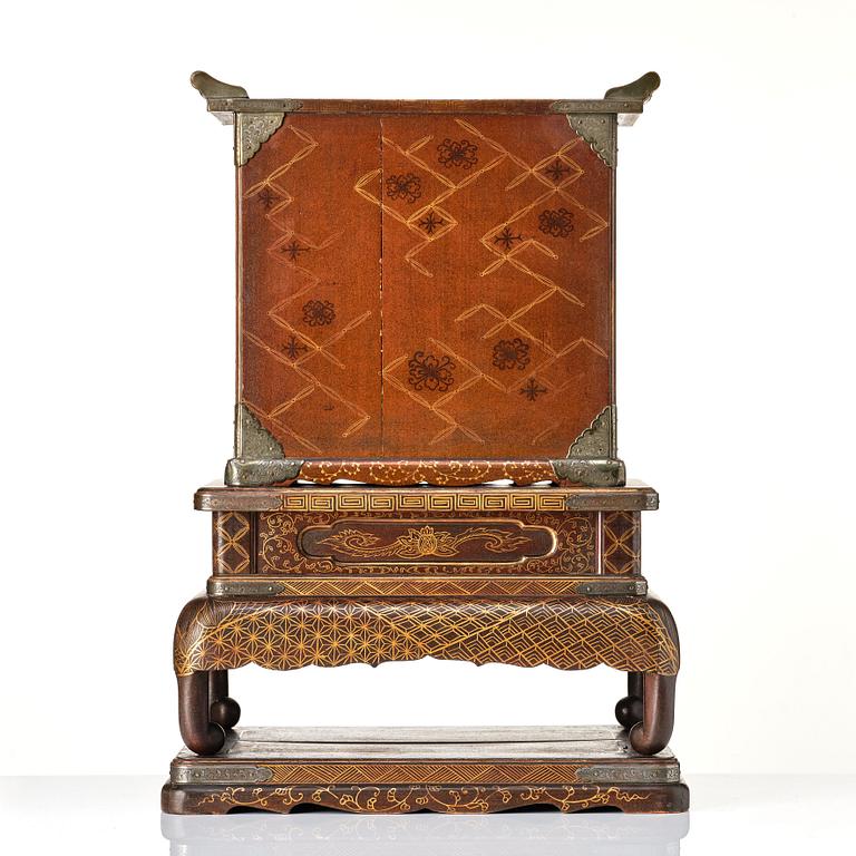 A Japanese lacquer cabinet on a stand, Meiji period (1868-1912).