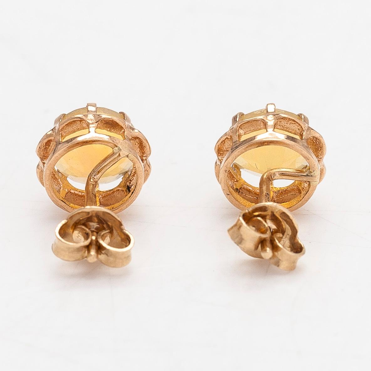 A pair of 14K gold earrings with opals.