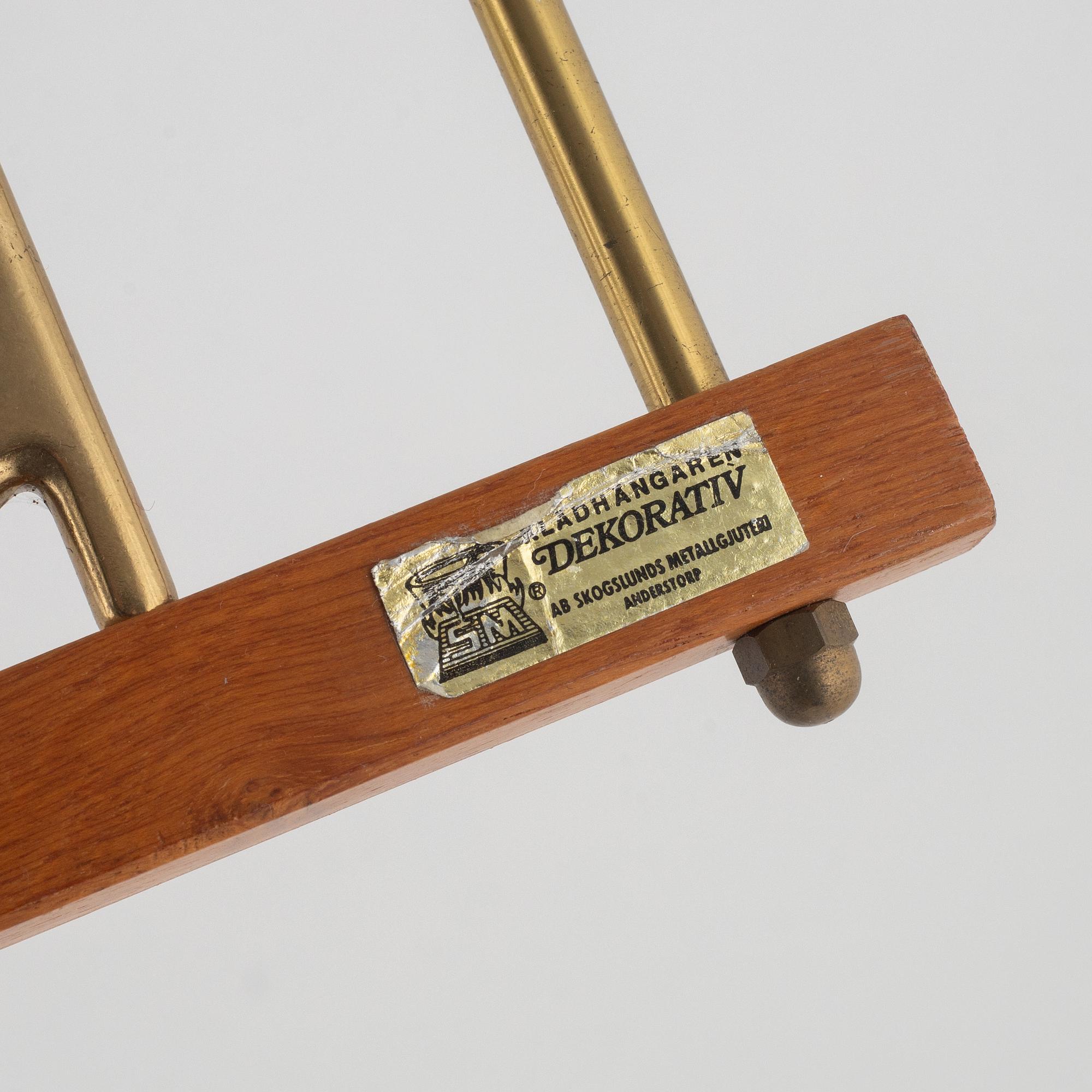A pair of 'Dekorativ' coat hangers, Skoglunds metallgjuteri, Anderstorp, mid 20th Century.