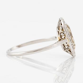 A ring in 18K white gold set with a yellow faceted tourmaline and rose-cut diamonds.