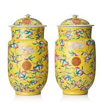 A pair of yellow glazed peach and bat vases with covers, Qing dynasty, 19th Century.