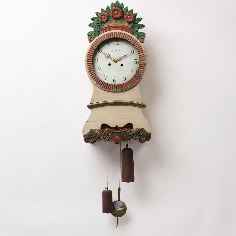 a painted wall pendulum clock from Ångermanland in the first half of the 19th century.
