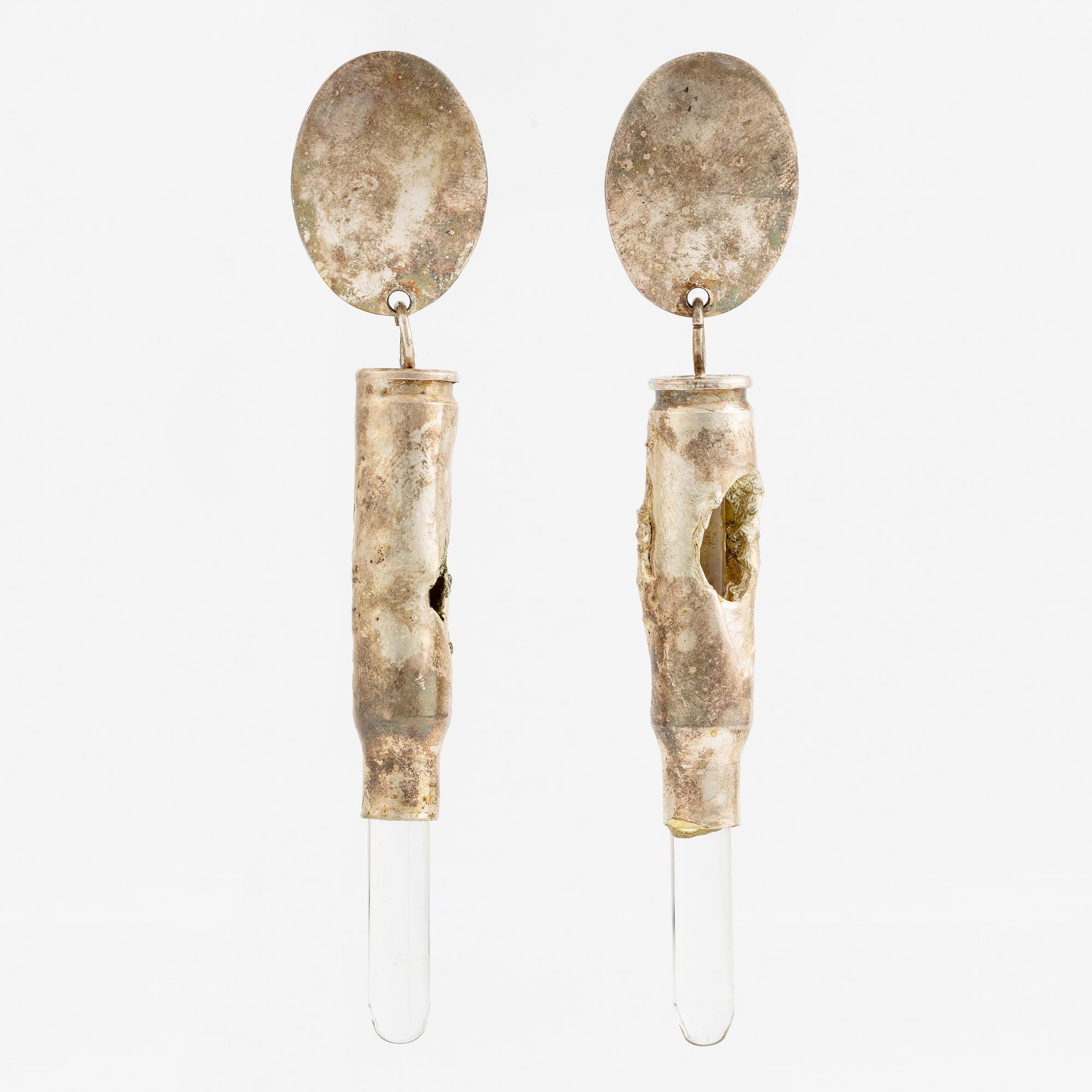 Earrings, possibly Slim Barrett.