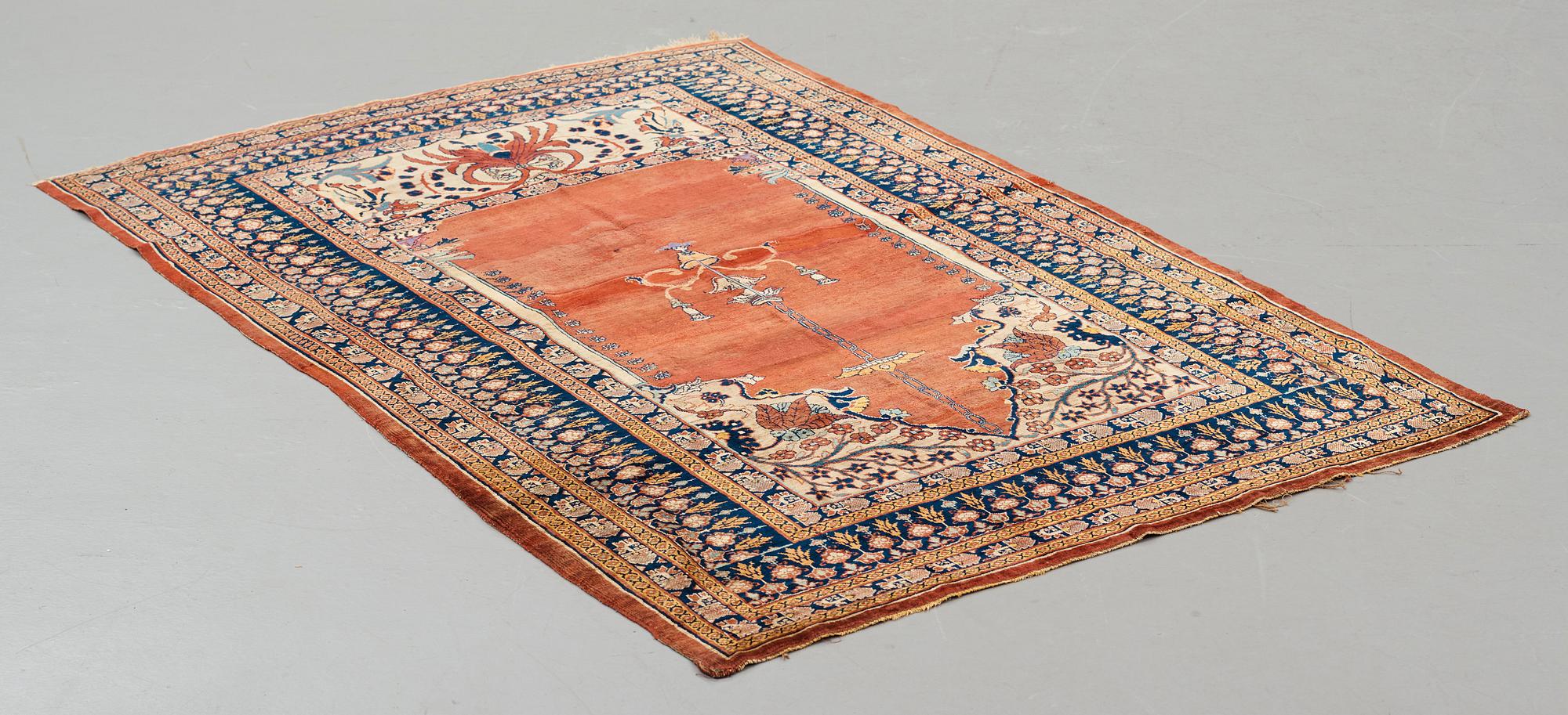 A rug, an antique silk Heriz, ca 166,5-170 cm x 116-120 cm.