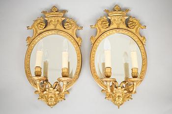 723. A pair of late Baroque-style circa 1900 gilt bronze two-light girandole mirrors.