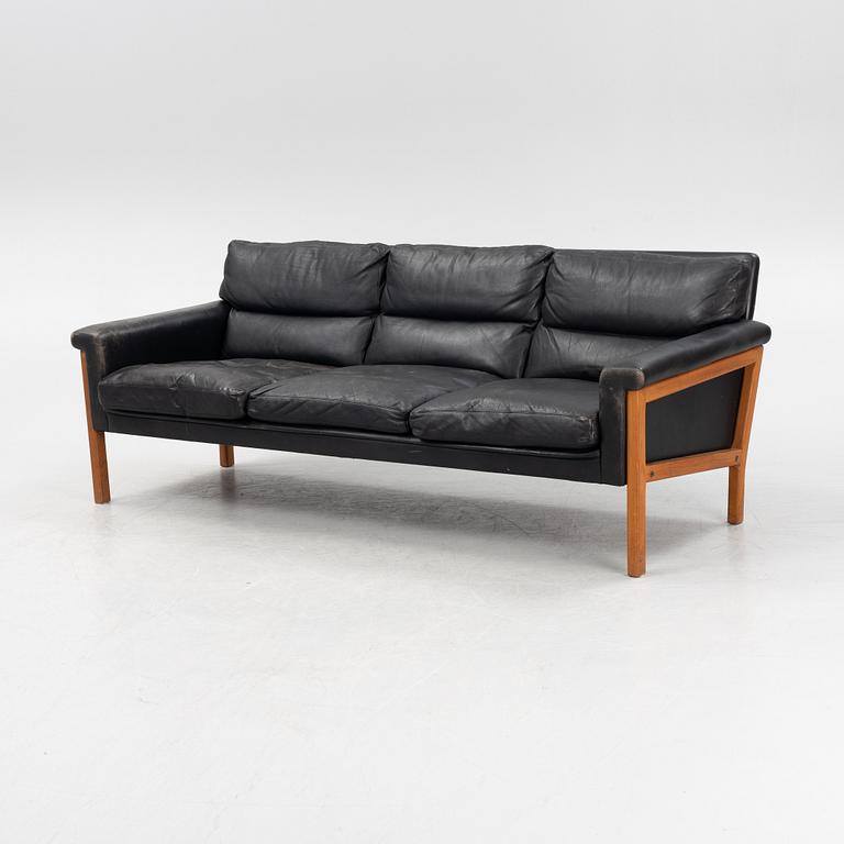 A leather and teak sofa, 1960-70s.