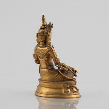 A gilt copper figure of a Buddha, 20th century.