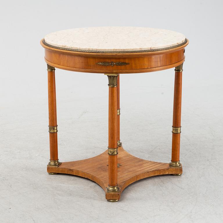 A table with marble top and brass mountings from around year 1900.