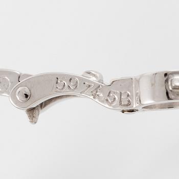 Cartier a pair of earrings platinum set with drop-shaped and round brilliant-cut diamonds.